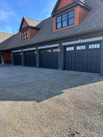 Black carriage style residential garage doors installed by A&K Metal and Doors in Southern Ohio